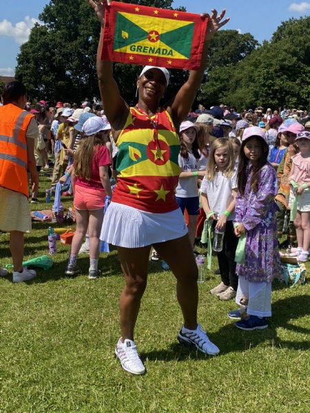 Janice Irwin holding a Grenada flag